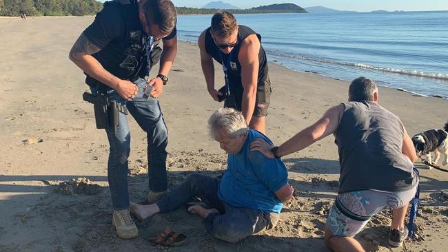 Peter Foster is arrested by detectives on a Port Douglas beach in 2020. Picture: IFW Global