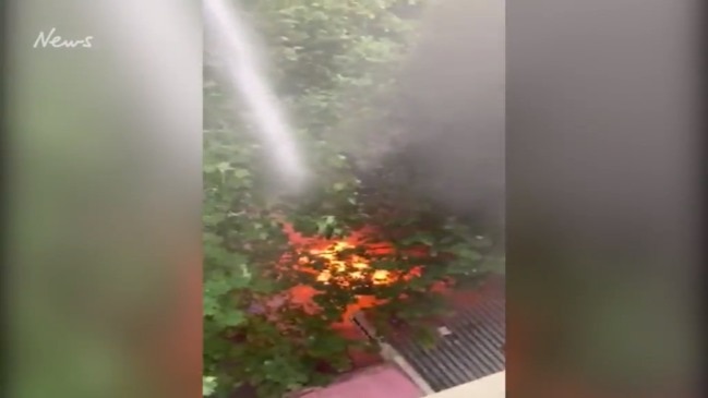 Man extinguishes the Bourke St fire from rooftop