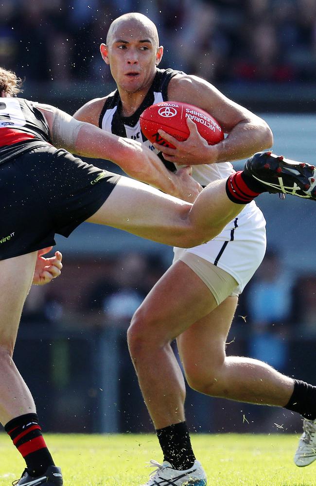 Alex Woodward pushes off Essendon's Heath Hocking.