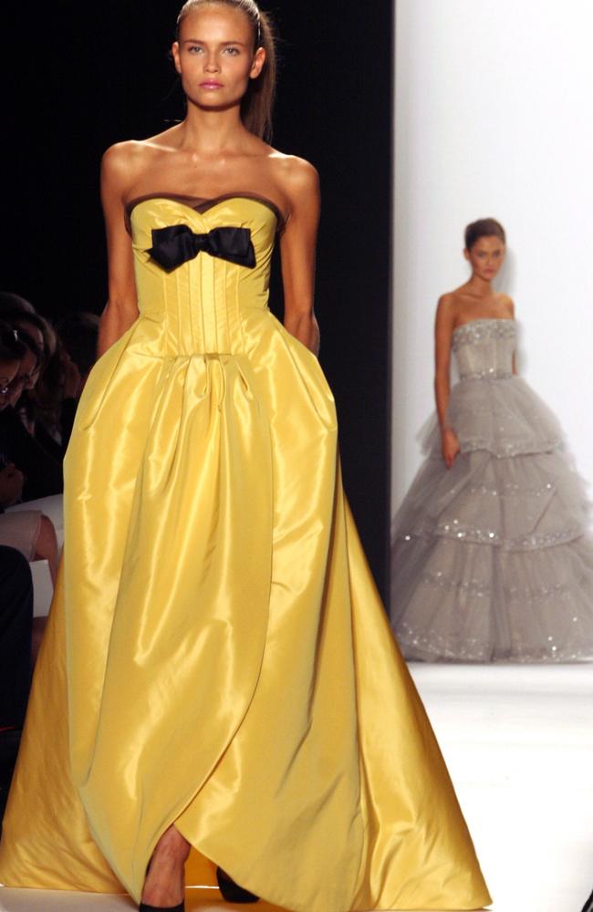 A striking yellow faille evening dress with black bow from his 2006 collection. Picture: AP Photo/Bebeto Matthews