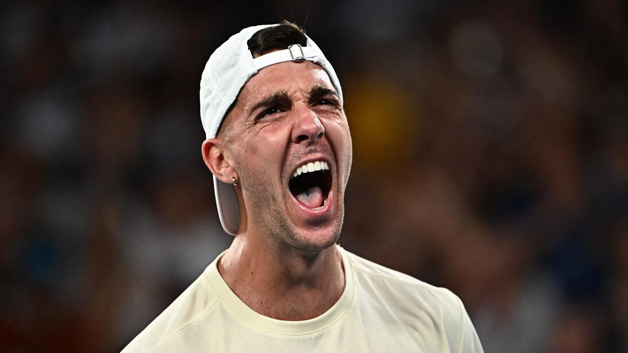 'Thanasi Kokkinakis reacts after his epic five-set win. (Photo by Lillian SUWANRUMPHA / AFP)