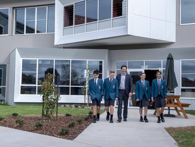 Students Jack, Thomas, Lili and Beth tour the new campus with proud principal Sean Butler.