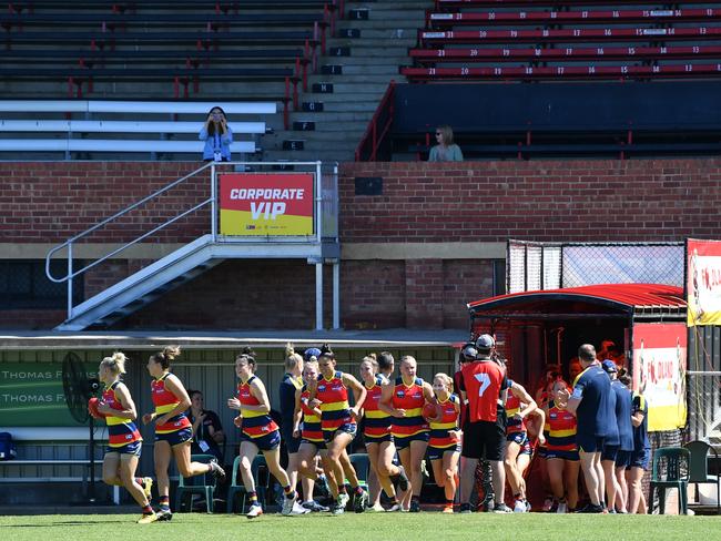 Crows players run onto the field during the Round 6 AFLW match between the Adelaide Crows and GWS Giants at Richmond Oval in Adelaide, Sunday, March 15, 2020. (AAP Image/David Mariuz) NO ARCHIVING, EDITORIAL USE ONLY