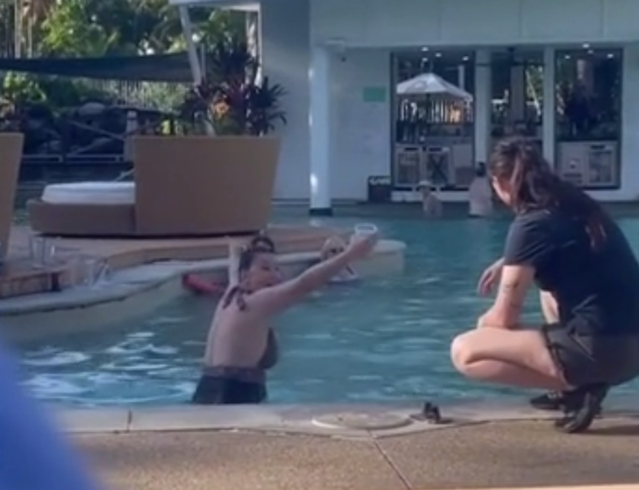 The woman was filmed screaming at staff after being told she couldn’t have her drink in the pool.