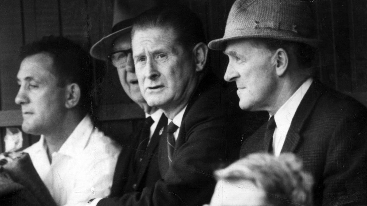 1965? Melbourne coach Norm Smith watches the game with Melbourne committeemen 'Checker' Hughes (left) and Harry Long. Frank Hughes. Picture: Photo File