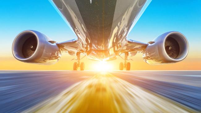 Passenger airplane accelerates at high speed view from below with bright light
