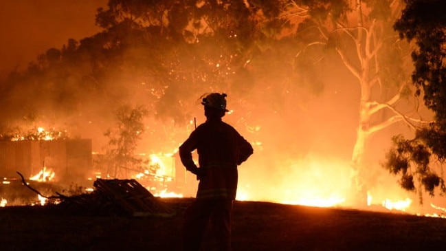 A volunteer firefighter at the 2021 Cherry Gardens bushfire rages. Picture: CFS