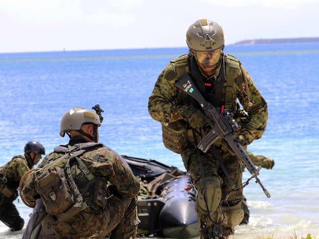 Japanese soldiers use rubber rafts as part of an amphibious drill during joint military exercises between the US, Japan, France and UK on Naval Base Guam. North Korea says it is examining its operational plans for attacking Guam to contain US facilities there. Picture: AP