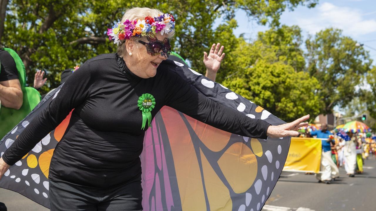 Mary Lewis reacts to the crowd while walking with the Darling Downs Irish Club entry in the Grand Central Floral Parade of Carnival of Flowers 2022, Saturday, September 17, 2022. Picture: Kevin Farmer