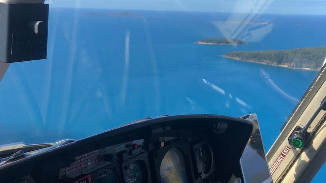 The RACQ CQ Rescue helicopter was called to Airlie Beach to airlift two people reportedly bitten by a shark. Picture: @cq_rescue/Twitter