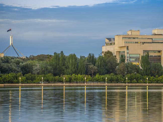 High Court of Australia from across Lake Burley Griffin with Parliament House Flag Pole in the background