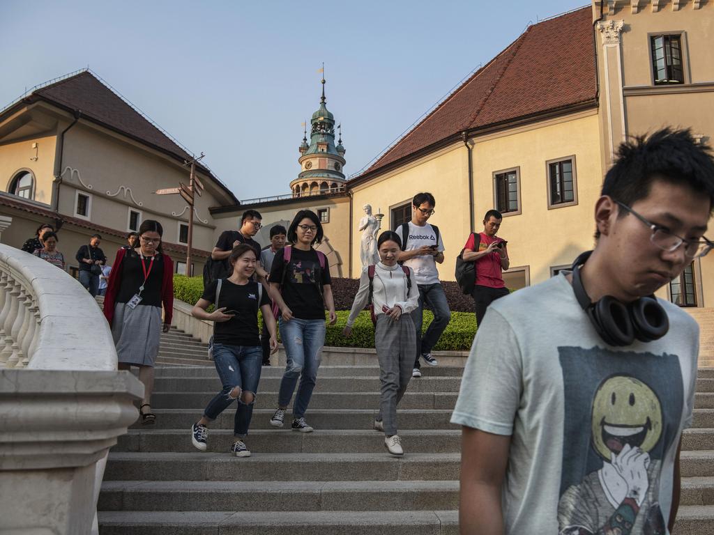 Huawei workers walk out together at the end of the day. Picture: Getty