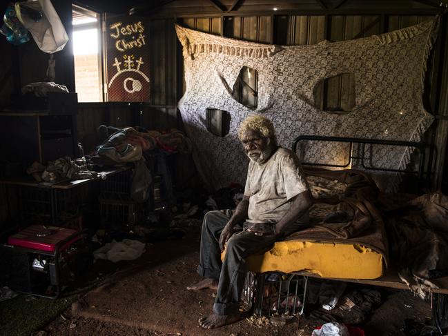 Steven Camfoo, 58, in his home at Drive-In Camp, named for the long-since shuttered drive-in cinema nearby in Tennant Creek. Although disconnected from basic services, Camfoo, who has lived here for about 10 years, says he would have to wait another five to six years for housing availability in Tennant Creek. Picture: Andrew Quilty/Climate Council