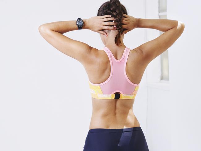 Rearview shot of an attractive young woman stretching for a workout