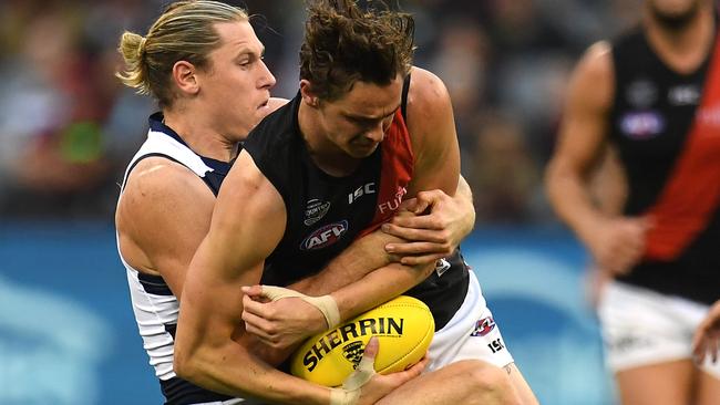 Mark Blicavs wraps up Joe Daniher in a tackle. Picture: AAP