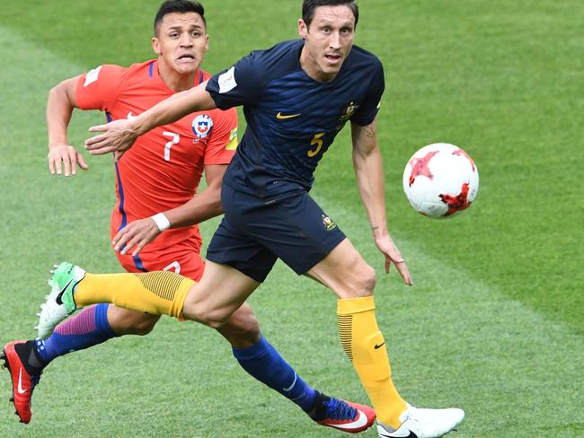 Melbourne Victory are waiting for the international clearance of Mark Milligan (right). Picture: AFP