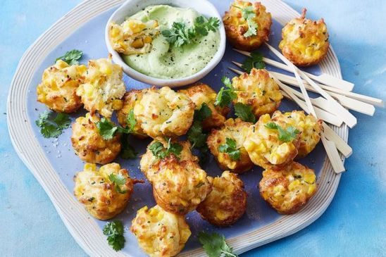 Haloumi and corn fritter bites with creamy avocado dip