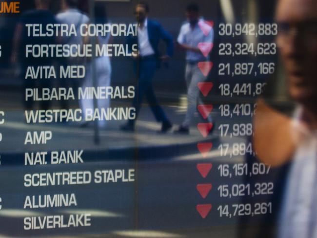 SYDNEY, AUSTRALIA - MARCH 13: A man looks at the electronic display of stocks at the Australian Stock Exchange on March 13, 2020 in Sydney, Australia. The ASX200 plunged more than 7 percent in the first 15 minutes of trade on Friday, amid fears over the spread of COVID-19. The Australian sharemarket fall follows the worst day of trading on Thursday, which saw the worst losses since the Global Financial Crisis. (Photo by Jenny Evans/Getty Images) *** BESTPIX ***