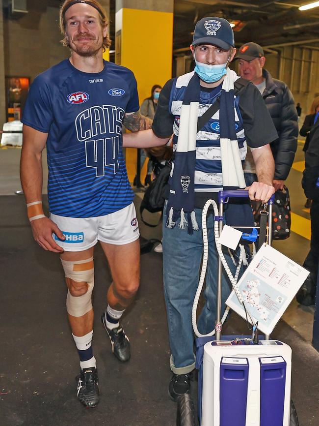 Angus walks into the Cats’ rooms with Tom Stewart. Photo: Michael Klein.