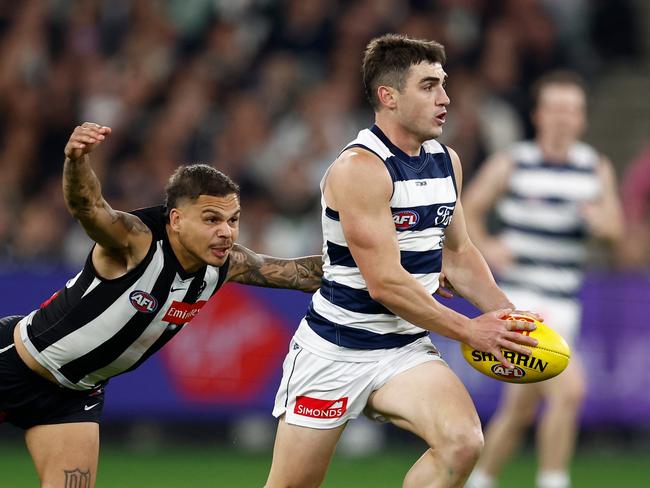 MELBOURNE, AUSTRALIA - MAY 03: Shaun Mannagh of the Cats is tackled by Bobby Hill of the Magpies during the 2025 AFL Round 08 match between the Collingwood Magpies and the Geelong Cats at the Melbourne Cricket Ground on May 3, 2025 in Melbourne, Australia. (Photo by Michael Willson/AFL Photos via Getty Images)