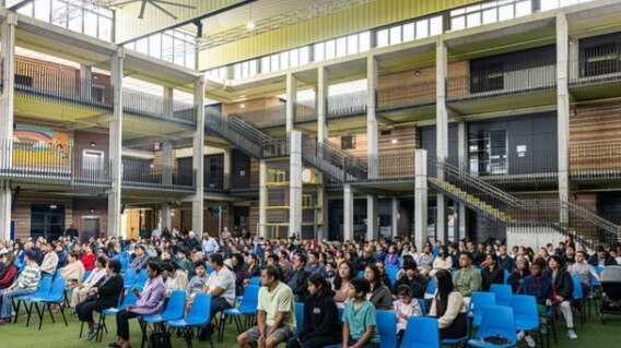 A Mass is held in the school’s performance hall.