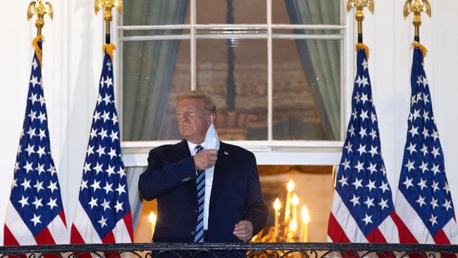 Donald Trump removes his mask upon return to the White House from Walter Reed National Military Medical Center after being hospitalised with coronavirus. Picture: Win McNamee/Getty Images