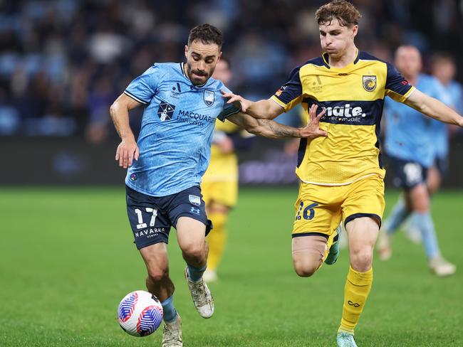 Sydney FC’s Anthony Caceres is challenged by Central Coast’s Bradley Tapp. Picture: Getty Images