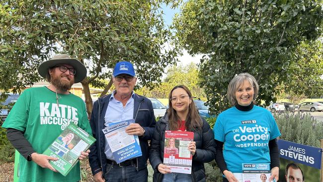 Volunteers Matthew Smith, Tony Zollo, May Harrington and Julie Miller offer up How to Vote brochures to the stream of voters coming into the Glynde Lutheran Church booth in eastern Adelaide. Picture: Duncan Evans/NewsWire