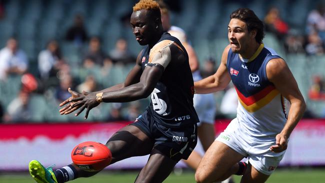 Emmanuel Irra gets his kick away, despite pressure from Adelaide’s Troy Menzel during their semi-final clash in September. Picture: Tom Huntley