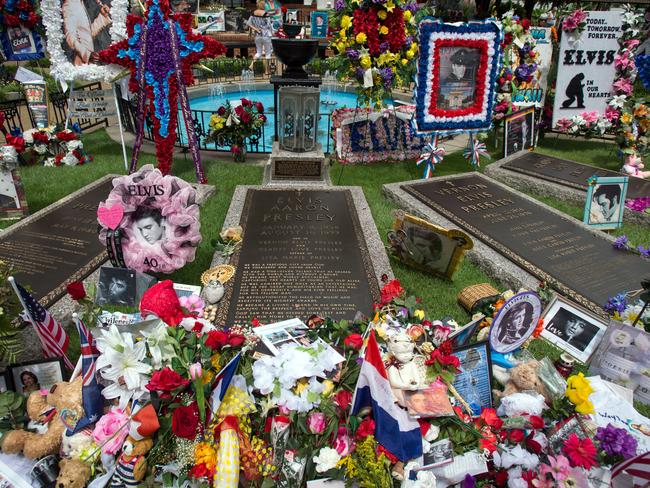 Flowers, signs and other memorial tributes left by fans filled Graceland’s Meditation Garden where The King is buried alongside his parents and grandmother. Picture: AP