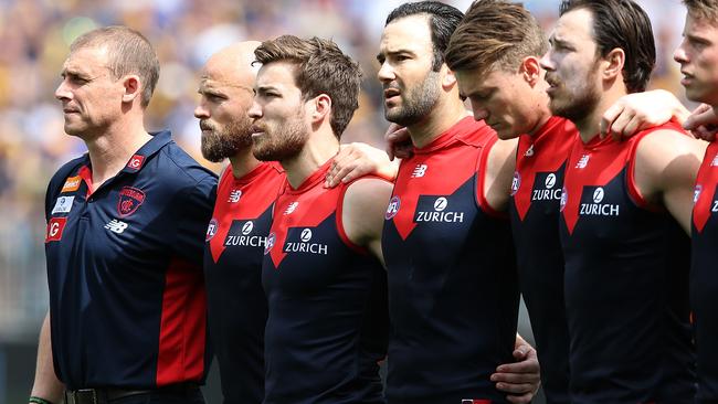 Calm before the storm as Goodwin shows solidarity with his Melbourne charges during the National Anthem before last year’s preliminary final loss to West Coast. Picture: Getty Images