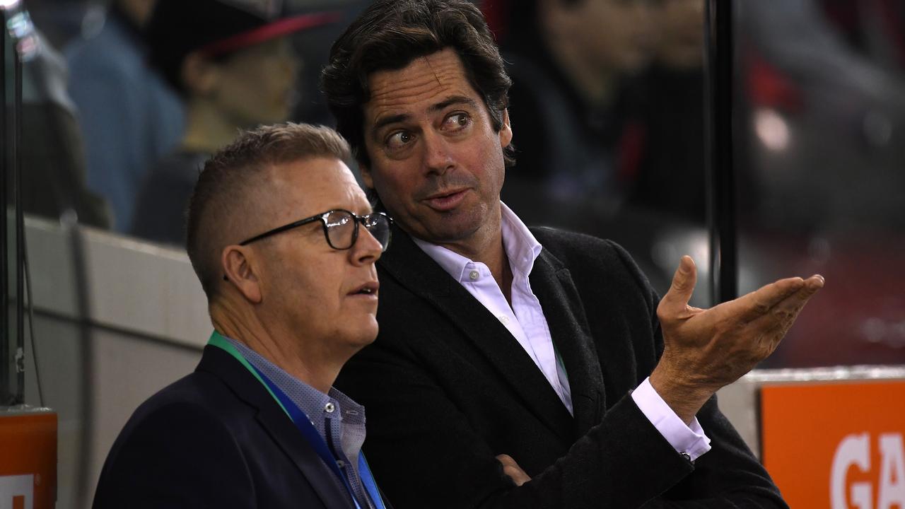 AFL football operations boss Steve Hocking (left) and AFL CEO Gillon McLachlan are seen in the interchange area during the Round 19 AFL match between the Essendon Bombers and the Sydney Swans at Etihad Stadium in Melbourne, Friday, July 27, 2018. (AAP Image/Julian Smith) NO ARCHIVING, EDITORIAL USE ONLY