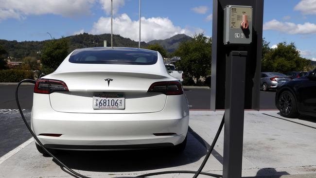 A Tesla car charging at a supercharger station in California.