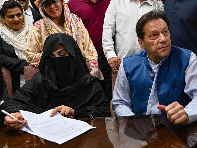 Imran Khan and wife Bushra Bibi sign bonds for bail at a registrar office in the High Court, in Lahore last year. Picture: AFP