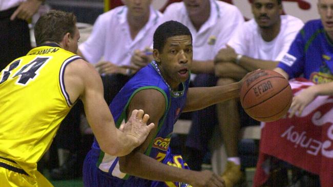 ## HAVE YOU /CHECKED COPYRIGHT /CLEARANCE ?? D/I 12 Jan 2002 - Townsville Crocodiles captain Robert Rose is watched by teammates (including new import Shawn Harvey) as he drives around Bris Bullets import Bobby Brannen. PicCAMERON/LAIRD sport basketball action