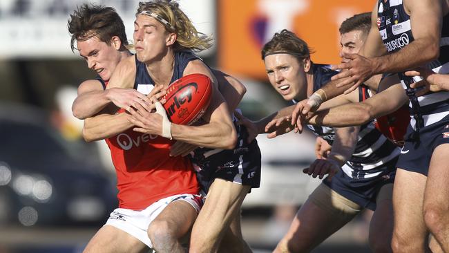 South Adelaide's Jaidan Kappler can’t escape the tackle of Norwood’s Cody Szust. Picture Dean Martin