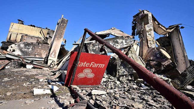 An insurance company sign sits amid the rubble of a building destroyed by the Palisades fire on Sunset Boulevard. Picture: AFP