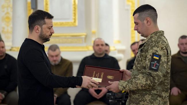 Ukrainian President Volodymyr Zelensky presenting an Order to a serviceman during a ceremony in Kyiv, amid the Russian invasion in Ukraine this week. Picture: AFP