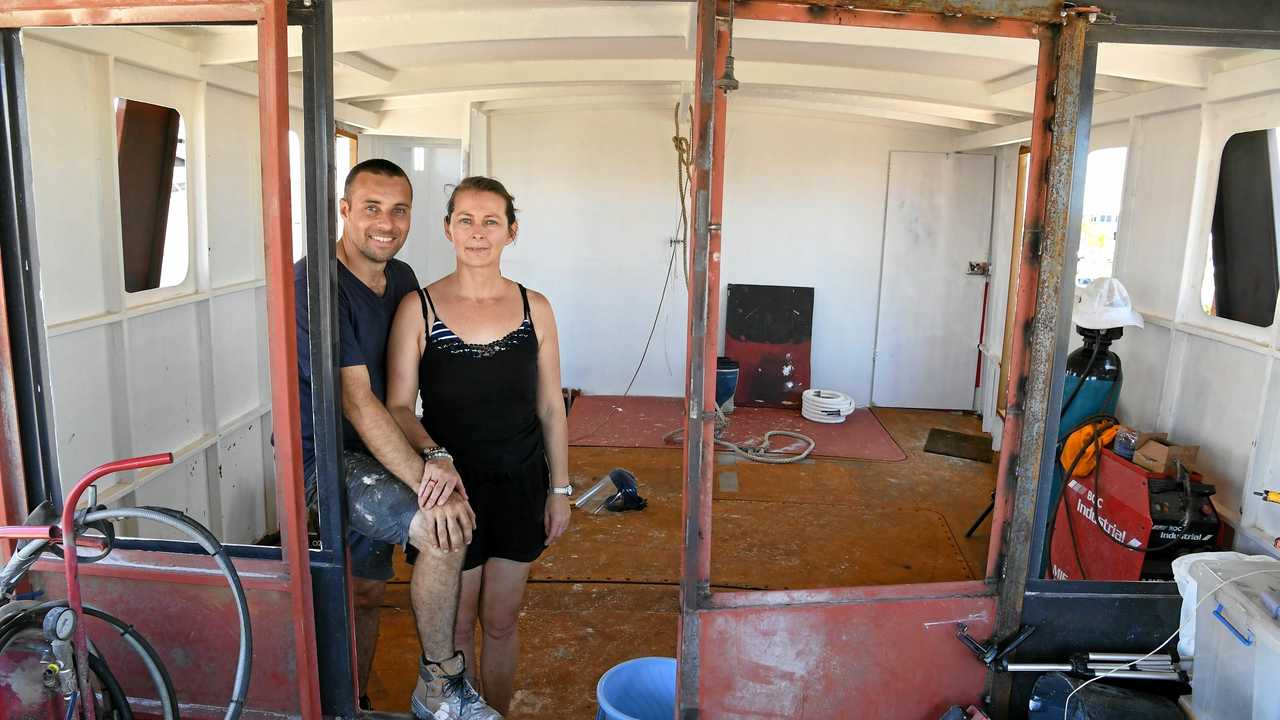 Damien and Jess Ashdown inside their boat Brupeg. Picture: Mike Knott BUN281217BRUPEG5