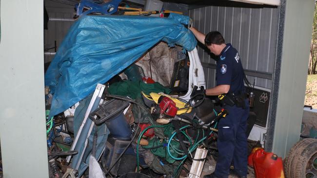 A scenes of crime officer inspects suspected stolen property uncovered at a Carters Ridge property, west of Eumundi, which was linked to a number of property offences between the Sunshine Coast and Gympie. Picture: Contributed