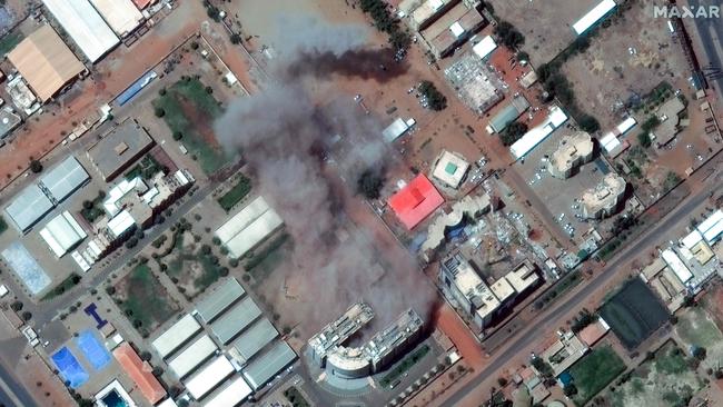 Smoke billows from a building near Khartoum airport. Picture: Maxar Technologies / AFP