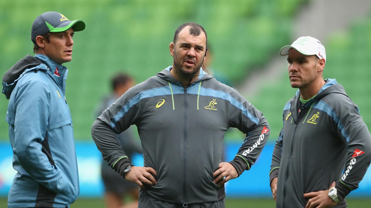 Wallabies coach Michael Cheika talks to Stephen Larkham and Nathan Grey.