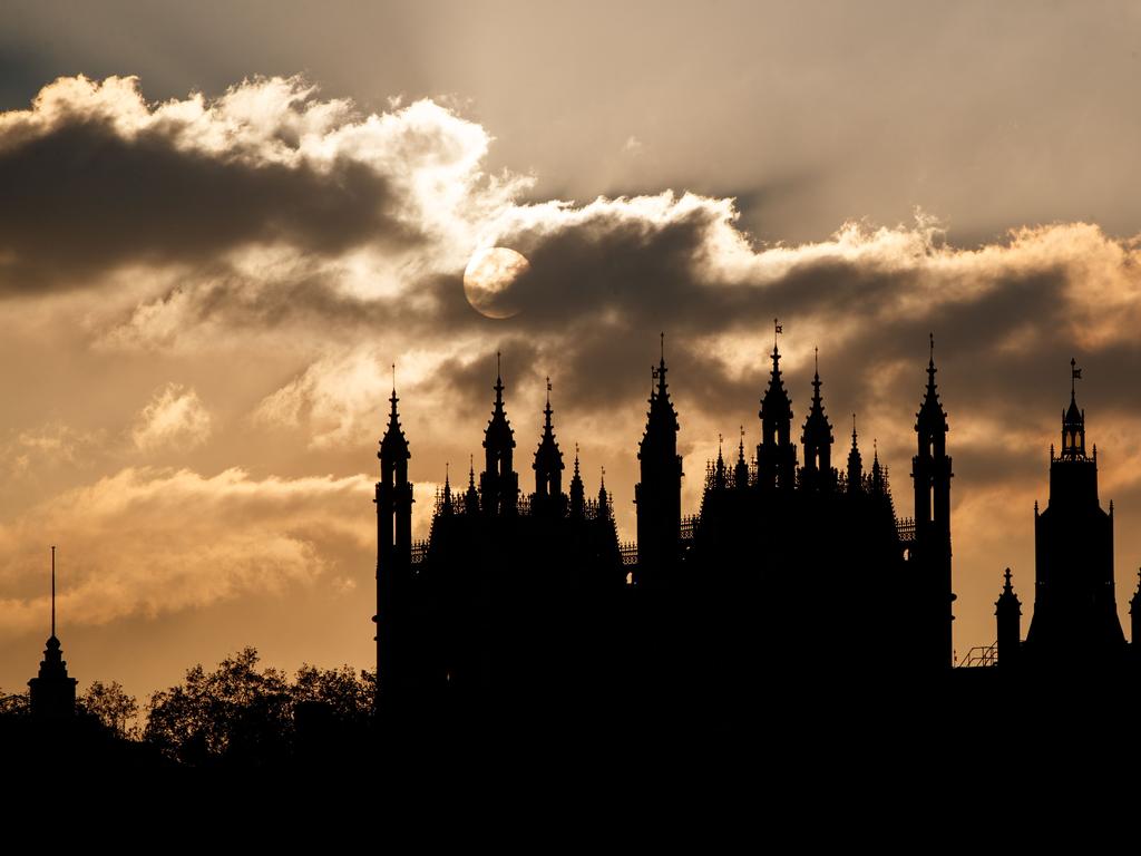 The sun sets behind the Houses of Parliament in London as debate rages about whether Mrs May and her Brexit strategy can be saved.