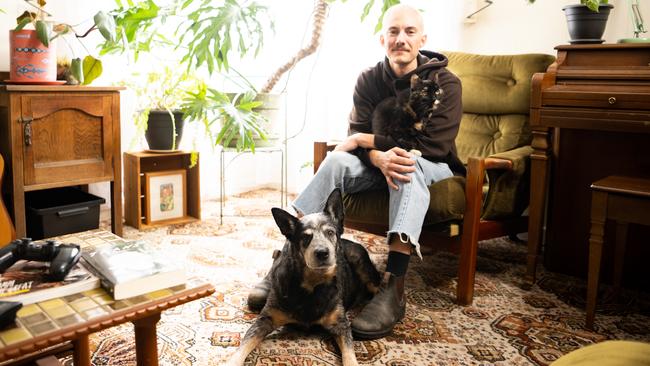 Elliot Oakes with his dog Harry and cat, Puddles, in South Plympton. Photo: Morgan Sette.