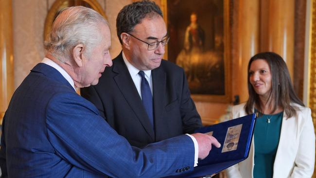 King Charles III (L) is reacts as Bank of England Governor Andrew Bailey (C) and Bank of England's Chief Cashier Sarah John present him with the first bank notes featuring his portrait, at Buckingham Palace. Picture: AFP