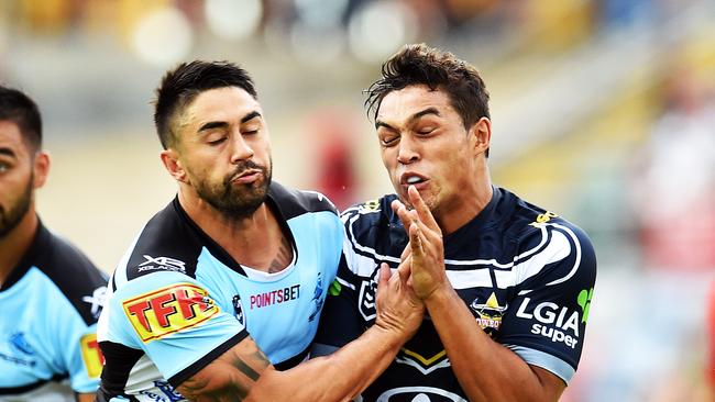 Round 3 match of the NRL Telstra Premiership between the North Queensland Cowboys v Cronulla Sharks from 1300 Smiles Stadium, Towsnville. Sharks Shaun Johnson tackled Cowboys Te Maire Martin. Picture: Zak Simmonds