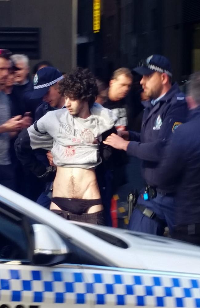 NSW Police hold the arrested man on Clarence Street in Sydney. Picture: Supplied