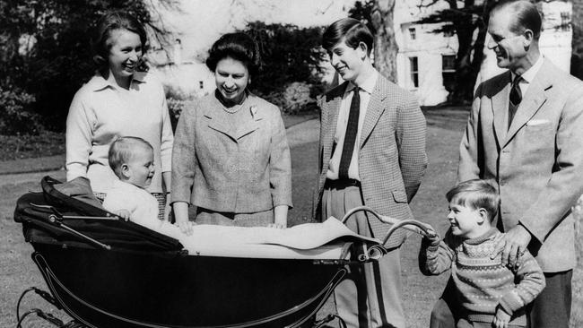 The British Royal Family: (from L to R) Princess Anne, Britain's Queen Elizabeth II, Prince Charles, Prince of Wales, Prince Philip, Duke of Edinburgh, Prince Andrew, Duke of York smiling at Prince Edward, Earl of Wessex, in his cradle in 1965. Picture: AFP.