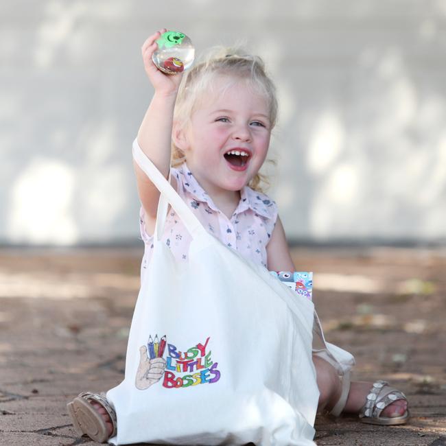 Tom Brewer’s niece Lucy Martin, 2, checking out one of his Busy Little Bosses bags. Picture: Sue Graham