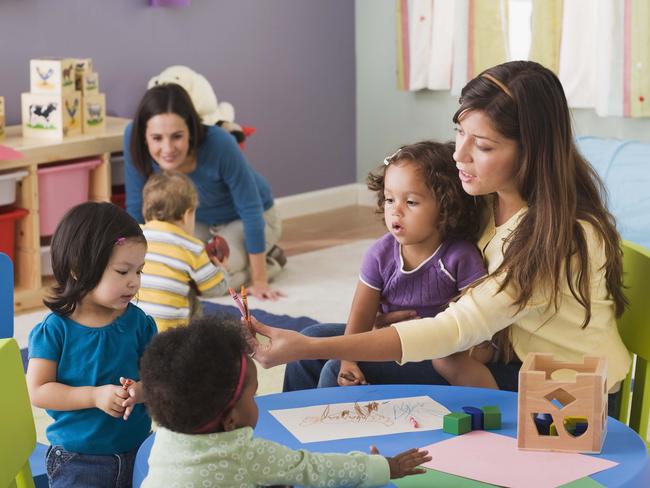 Teachers and toddlers in daycare.Preschool, Nursery School Building, Child, Child Care, Education, Teacher, Toddler, Learning, Messing About, Playing, Teaching, Childhood, Boys, Assistance, Latin American and Hispanic, Table, Toy, Group Of People,  Fun, Multiracial Group, Friendship, Girls, People, Adult, Indoors, Occupation, 18-23 Months, 25-29 Years, 30-39 Years, African-American Ethnicity, Asian, Blonde Hair, Brown Hair, Caucasian Appearance, Cheerful, Colour Image, Colouring, Crayon, Cute, Daycare, Filipino, Growth, Horizontal, Large Group Of People, Latin, Thinkstock, Generic, Childcare